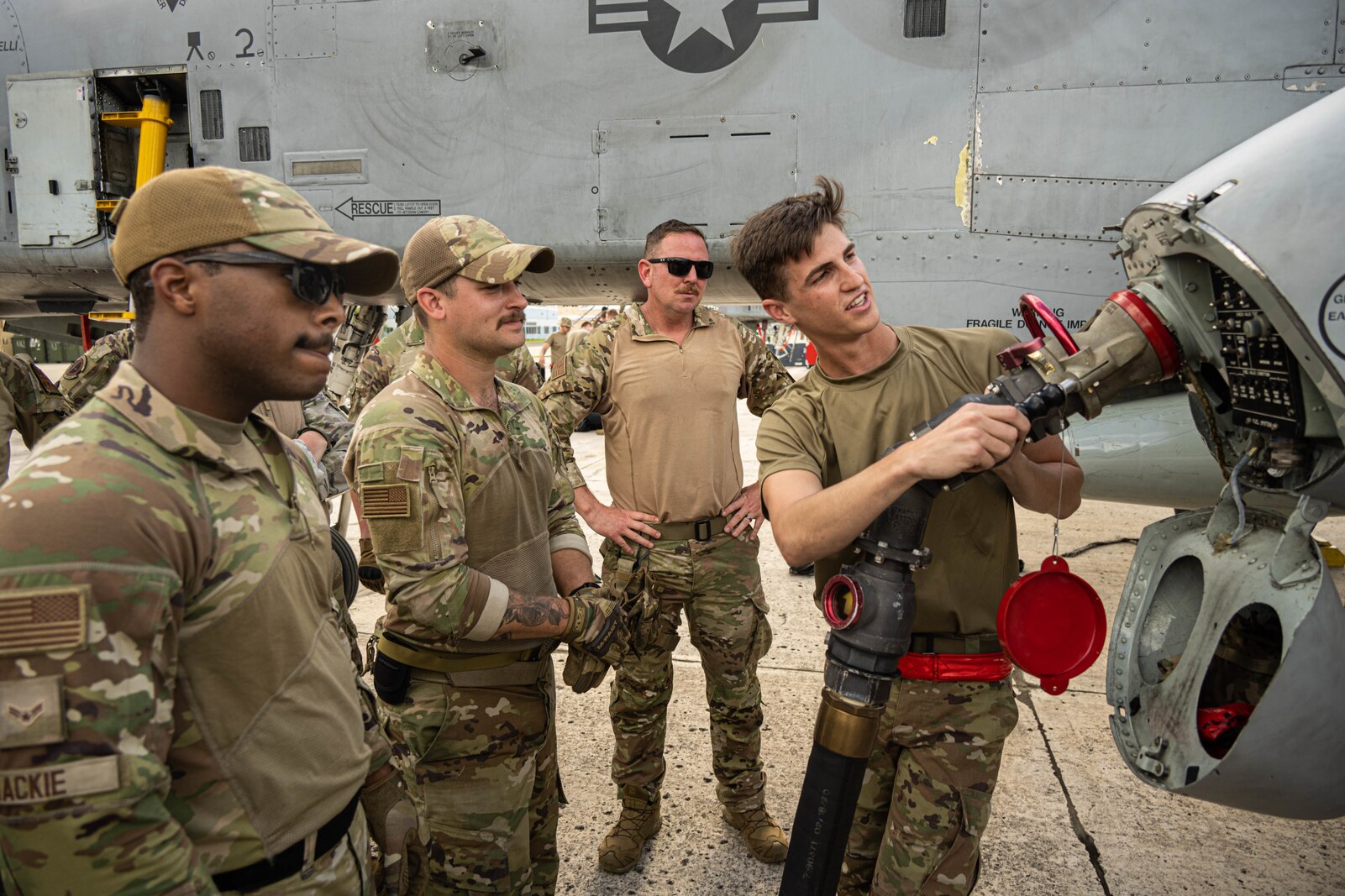 Airmen explains about refueling an A-10 on the flight line.