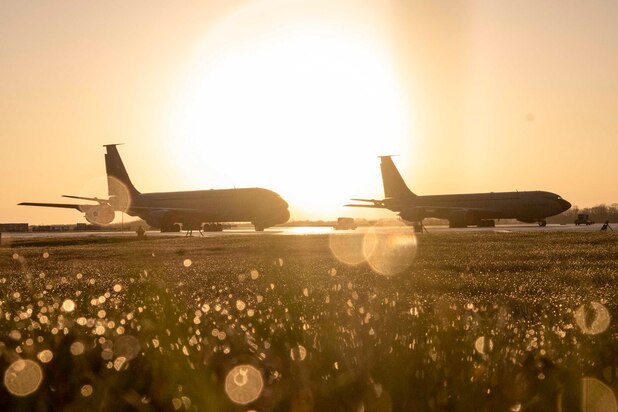 Two aircraft shown in silhouette sit parked side by side.
