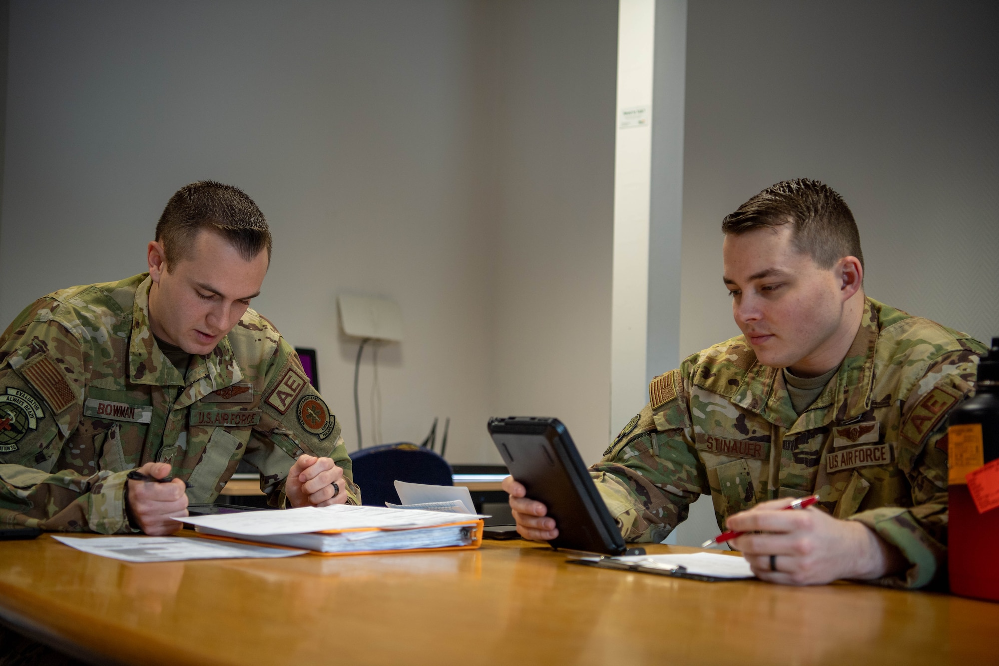 Tech. Sgt. Brendon Bowman, 86th Aeromedical Evacuation Squadron flight examiner and emergency medical paramedic, left, and Tech. Sgt. Alexander Stinauer, 86th AES aeromedical evacuation technician, right, prepares for a patient transfer flight at Ramstein Air Base, Germany, April 6, 2023.
