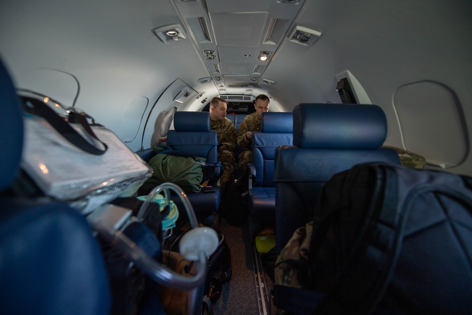 Tech. Sgt. Alexander Stinauer, 86th Aeromedical Evacuation Squadron aeromedical evacuation technician, left, and Tech. Sgt. Brendon Bowman, 86th AES  flight examiner and emergency medical paramedic, right, reviews patient documents from Ramstein Air Base, Germany, to Vilnius International Airport, Lithuania, April 6, 2023.