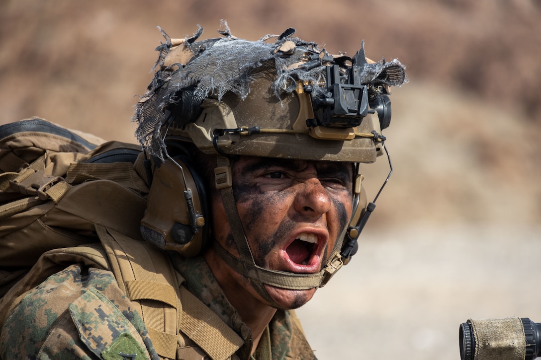 U.S. Marine Corps Lance Cpl. Jose Sardina Jr, a rifleman with 3rd Battalion, 5th Marine Regiment, 1st Marine Division, passes commands to his squad during a company level attack exercise at Marine Corps Air Ground Combat Center, Twentynine Palms, California, March 7, 2023. Company level training ensures that Marines are trained in breaching obstacles, working under pressure, and adapting to changing scenarios. (U.S. Marine Corps photo by Lance Cpl. Anna Higman)