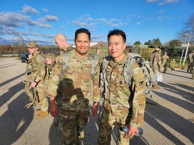 Sgts. 1st Class David Trujillo, left, and Peung Kim are pictured after completing the Norwegian Foot March at Fort Belvoir, Virginia, April 2, 2023. The endurance test, inspired by the Norwegian Army and dating back to 1915, requires Soldiers to cover 18.6 miles with a 25-pound rucksack under a specified time based on age and gender. (U.S. Army photo courtesy Sgt. 1st Class Peung Kim)