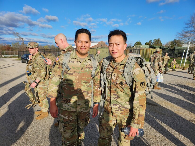 Sgts. 1st Class David Trujillo, left, and Peung Kim are pictured after completing the Norwegian Foot March at Fort Belvoir, Virginia, April 2, 2023. The endurance test, inspired by the Norwegian Army and dating back to 1915, requires Soldiers to cover 18.6 miles with a 25-pound rucksack under a specified time based on age and gender. (U.S. Army photo courtesy Sgt. 1st Class Peung Kim)