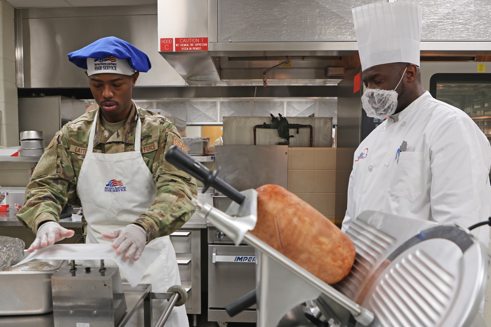 Two Airmen prepare food