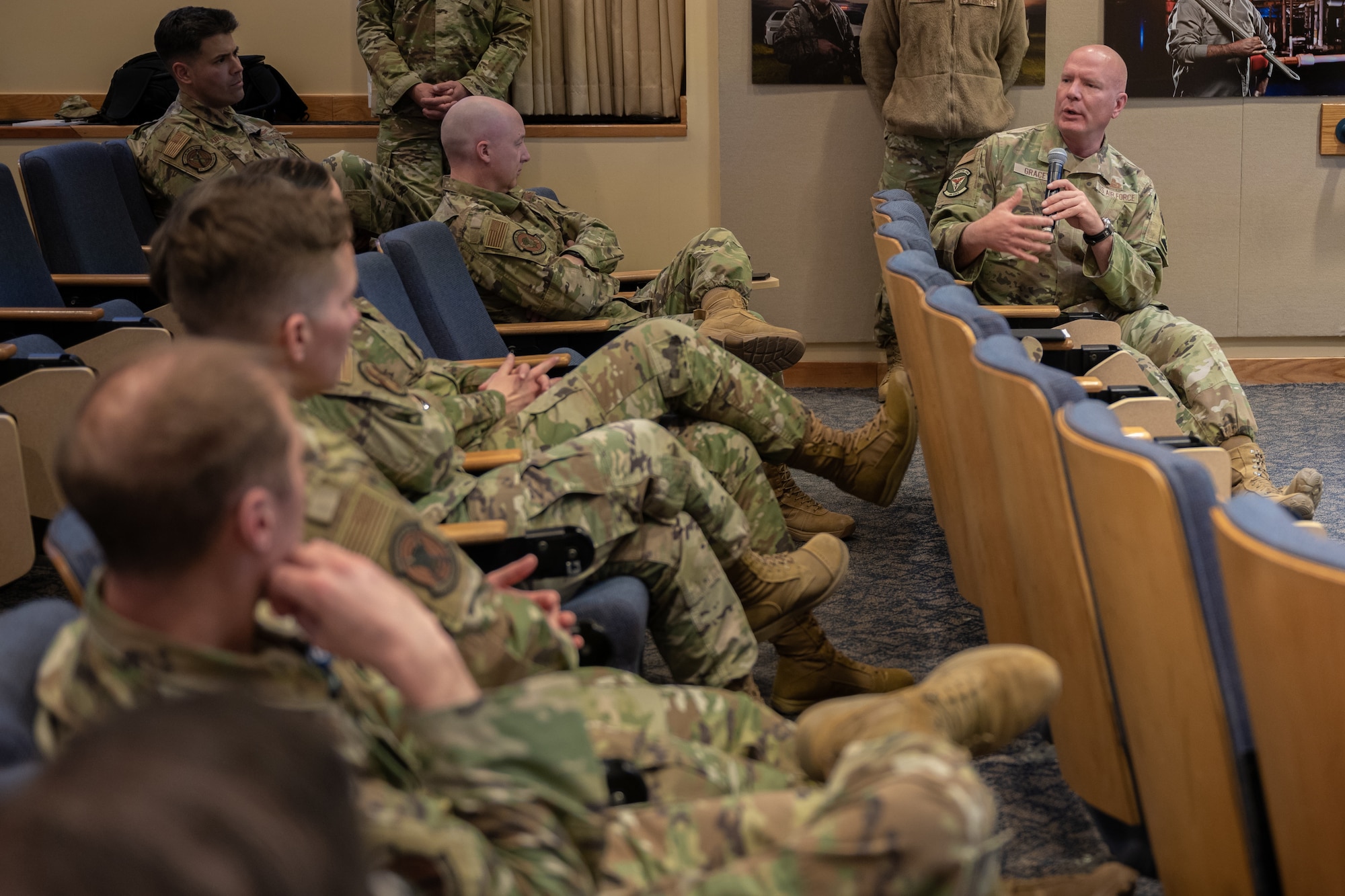 An individual in the audience speaks to the rest of the audience.