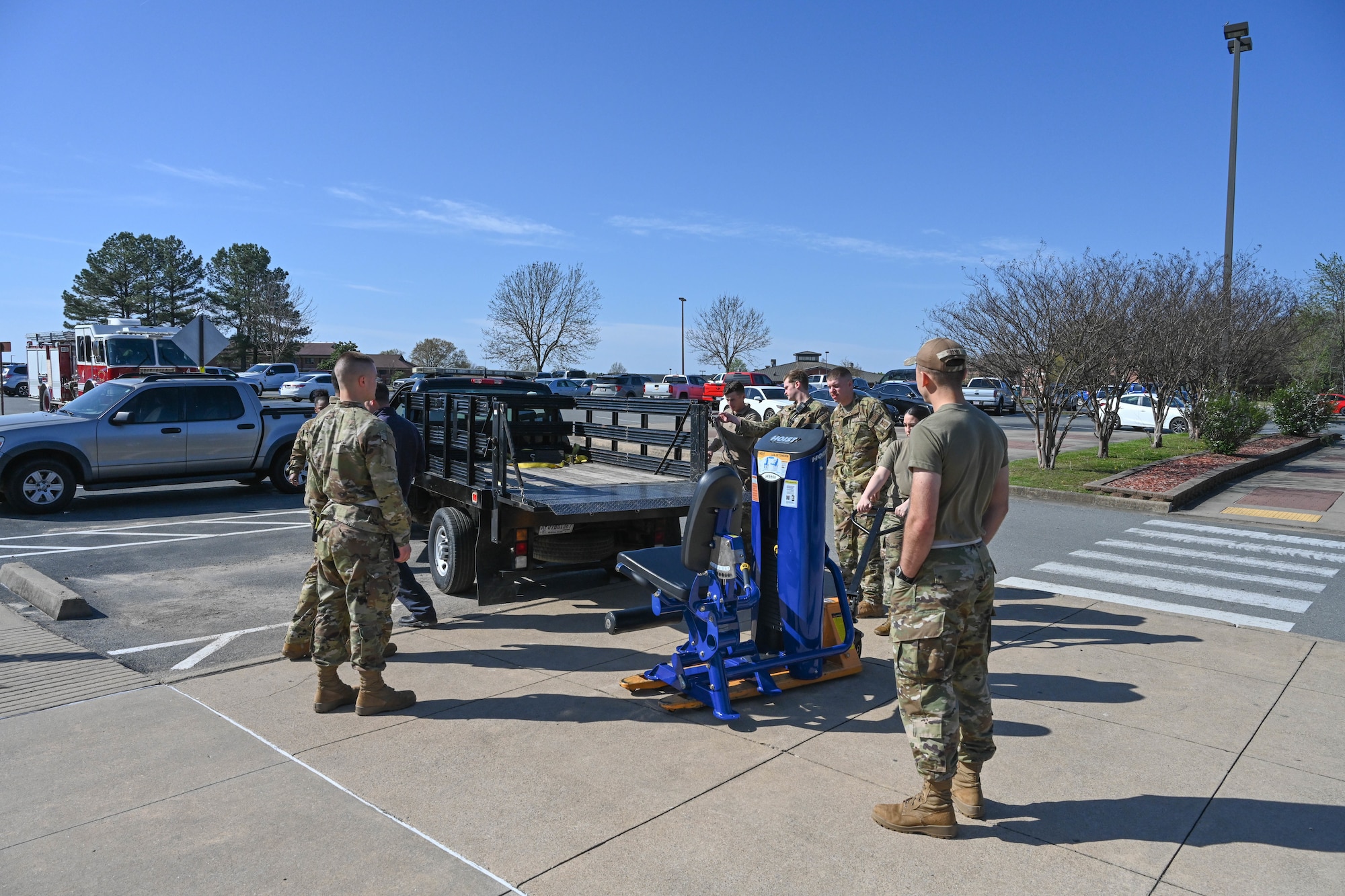 Airman load gym equipment onto a truck.