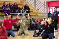 Alaska Army National Guard Staff Sgt. Eddie Jones, a Bethel-based recruiter, joins Andreafski High School students as they perform a traditional Yup’ik dance in St. Mary’s, Alaska, March 31, 2023. The Association of Village Council Presidents recently partnered with the Alaska National Guard to provide recruiting information and resources through their Tribal Job Centers. The initiative kicked off in St. Mary’s with presentations from AVCP and AKNG, where representatives interacted with students, parents, teachers, and community members. AVCP provides community development, education, social services, culturally relevant programs, and advocacy for the people and 56 tribes of Western Alaska.