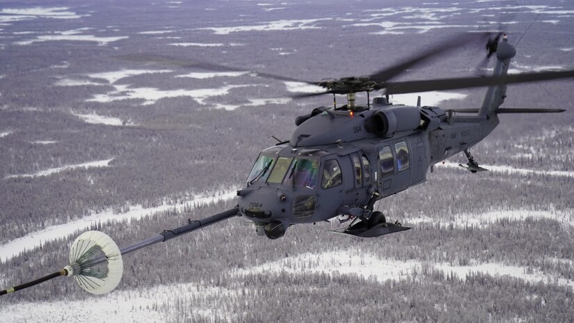 Alaska Air National Guardsmen with the 210th Rescue Squadron fly an HH-60G Pave Hawk helicopter during an air-to-air refuel from a 211th RQS HC-130J Combat King II aircraft over the Lower Susitna Valley near Anchorage, Alaska, Feb. 7, 2023. Both aircraft along with rescue personnel from the 212th RQS sit alert for the federal search and rescue mission across Alaska’s vast Arctic region. The HC-130J’s aerial refueling capability significantly extends the HH-60G Pave Hawk’s range for conducting search and recovery missions.