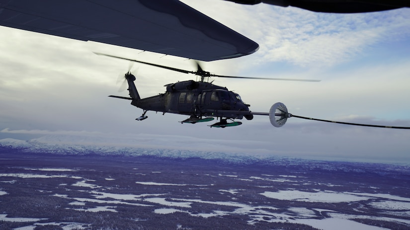 Alaska Air National Guardsmen with the 210th Rescue Squadron fly an HH-60G Pave Hawk helicopter during an air-to-air refuel from a 211th RQS HC-130J Combat King II aircraft over the Lower Susitna Valley near Anchorage, Alaska, Feb. 7, 2023. Both aircraft along with rescue personnel from the 212th RQS sit alert for the federal search and rescue mission across Alaska’s vast Arctic region. The HC-130J’s aerial refueling capability significantly extends the HH-60G Pave Hawk’s range for conducting search and recovery missions.