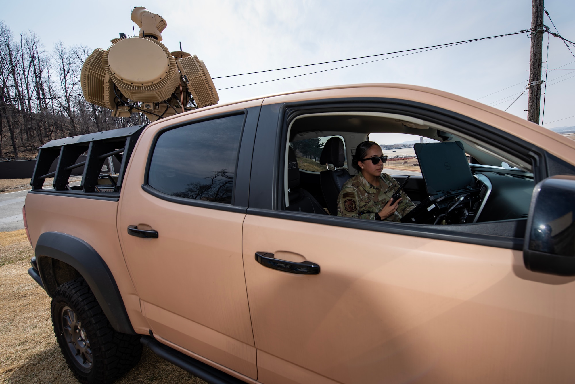 U.S Air Force Staff Sgt. Melissa Garcia, 51st Security Forces Squadron (SFS), small unmanned aircraft systems (sUAS), program manager, communicates with other security forces members while operating a counter small unmanned aircraft system (C-sUAS), during a bilateral C-sUAS training event, March 22, 2023, at Osan Air Base, Republic of Korea.