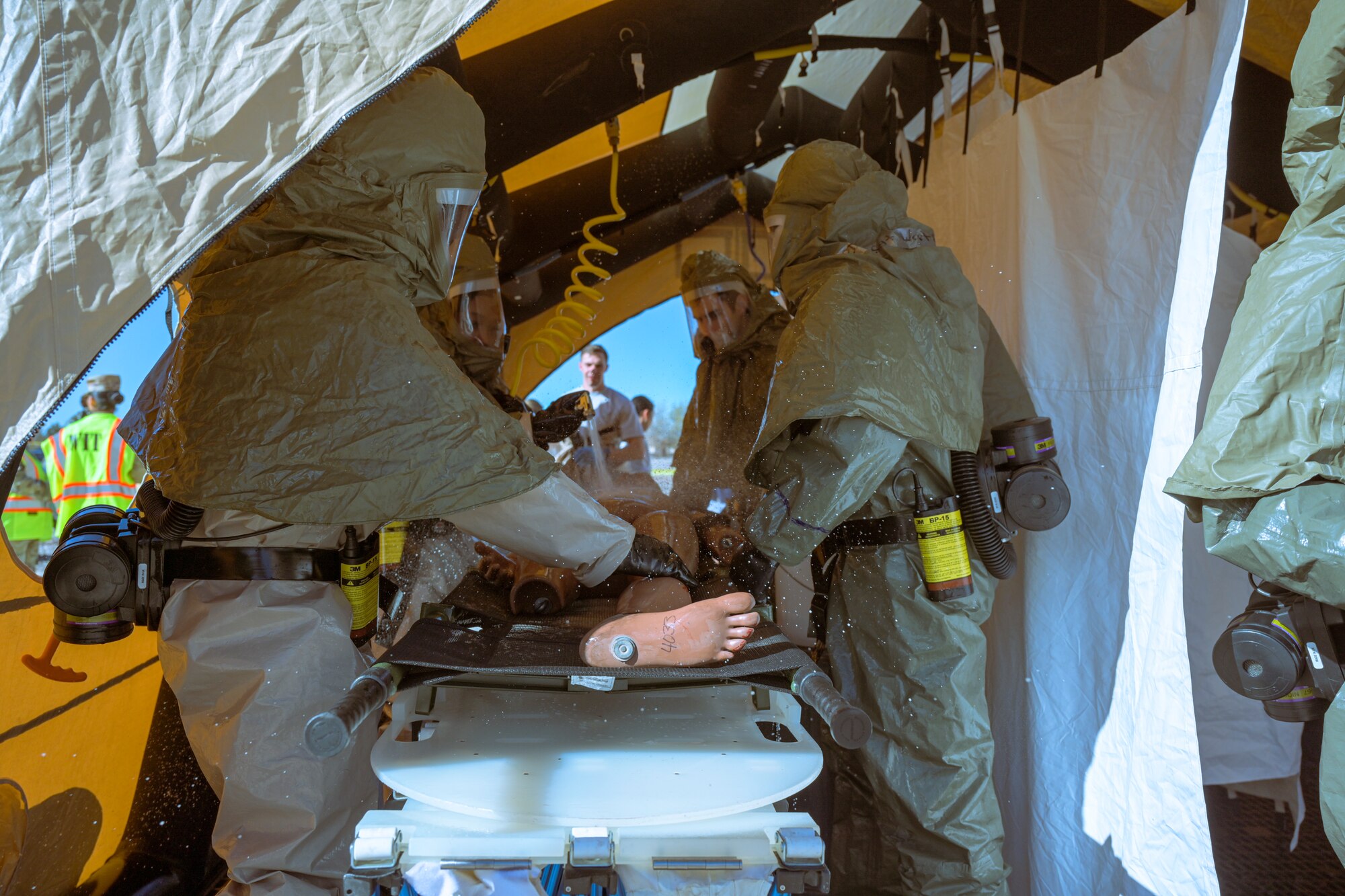 Members from the 49th Medical Group prepare a patient to be transported during a Ready Eagle exercise at Holloman Air Force Base, New Mexico, March 30, 2023. The initial response teams were responsible for on-the-scene care and patient transport. (U.S. Air Force by Senior Airman Antonio Salfran)