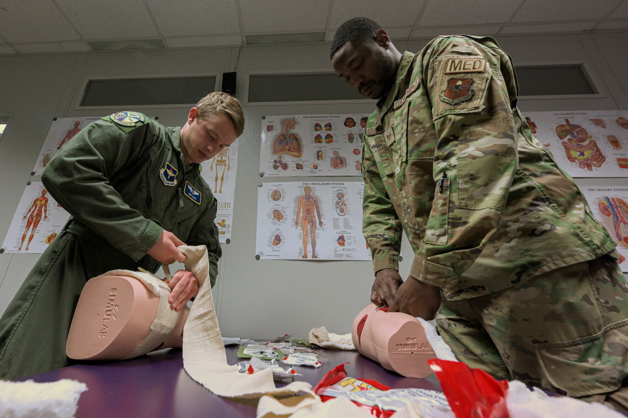 Members from the 49th Medical Group prepare a patient to be transported during a Ready Eagle exercise at Holloman Air Force Base, New Mexico, March 30, 2023. The initial response teams were responsible for on-the-scene care and patient transport. (U.S. Air Force by Senior Airman Antonio Salfran)