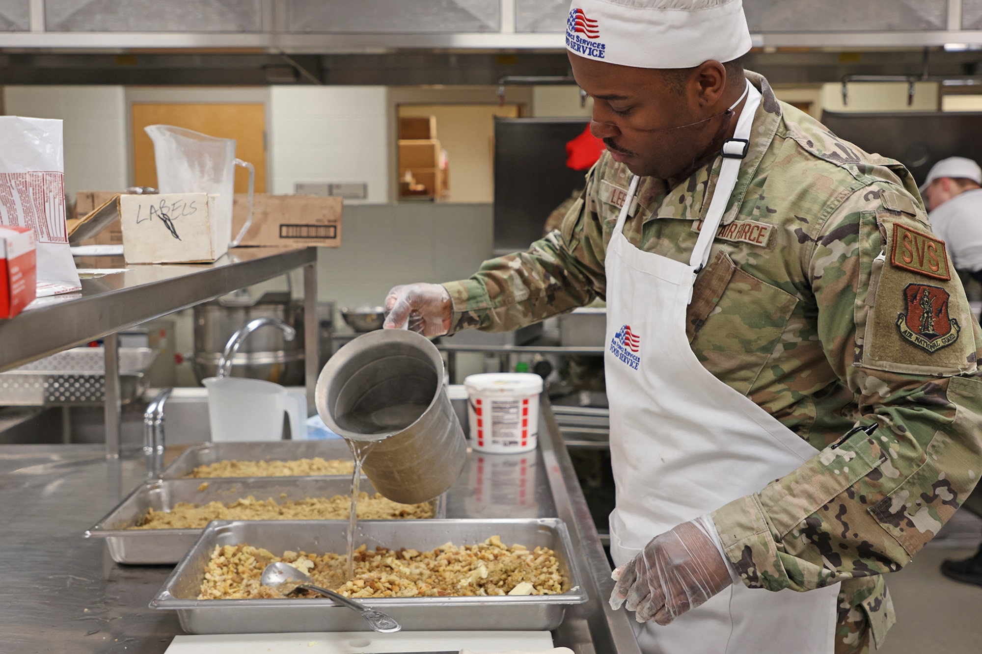 Airman pours water from pitcher