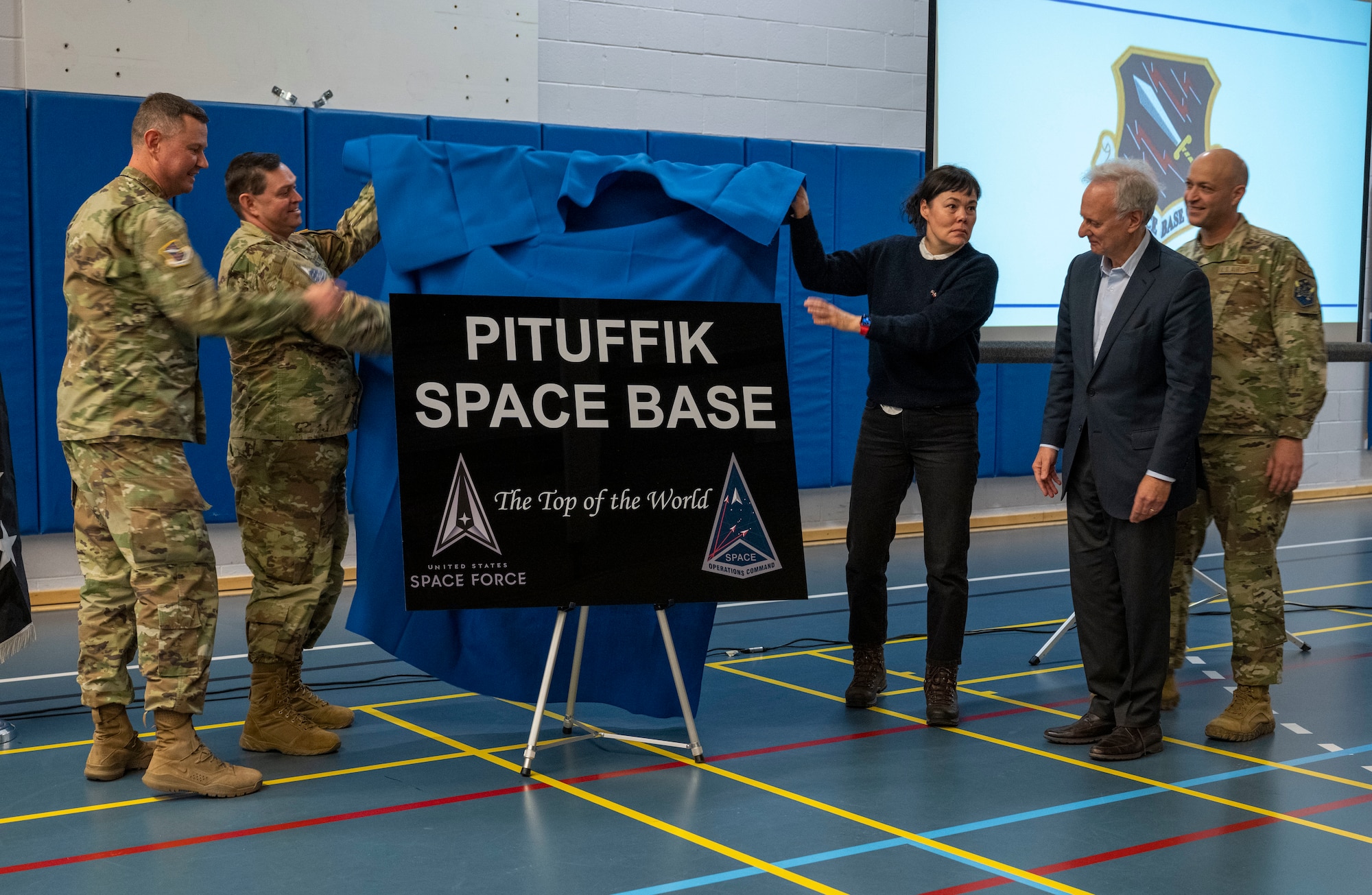 From left to right, Col. Brian Capps, 821st Space Base Group commander, Chief of Space Operations U.S. Space Force Gen. Chance Saltzman, Greenlandic Minister Affairs, Business and Trade Vivian Motzfeldt, U.S. Ambassador to the Kingdom of Denmark Alan Leventhal and Chief Master Sgt. Christopher Clark, 821st Space Group command chief, unveil the new base sign during the base renaming ceremony, at Pituffik Space Base, Greenland, April 6, 2023. The ceremony took place in the fitness center where distinguished guests and Greenlandic community members attended the historic event. (U.S. Space Force photo by Senior Airman Kaitlin Castillo)
