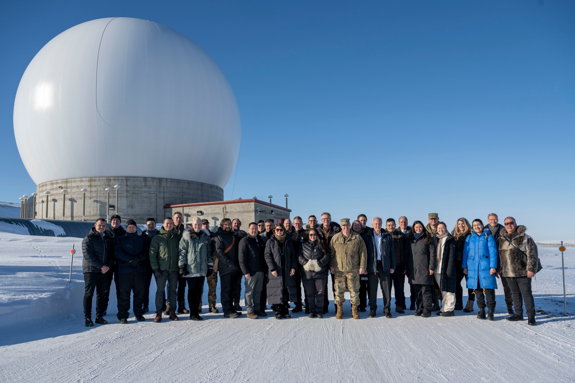 Chief of Space Operations U.S. Space Force Gen. Chance Saltzman and distinguished guests stand in front of a radar dome belonging to the 23rd Space Operations Squadron Detachment 1 at Pituffik Space Base, Greenland, April 5, 2023. Det. 1 falls under Space Delta 6 - Space Access and Cyberspace Operations. The Det. 1 mission is to provide telemetry, tracking and commanding operations to the U.S. and allied government satellite programs. (U.S. Space Force photo by Senior Airman Kaitlin Castillo)