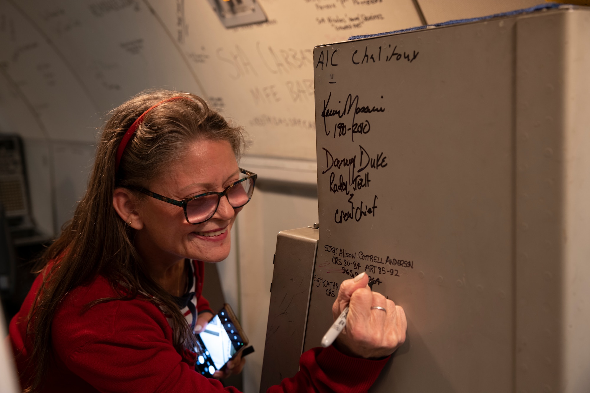 Woman signing her name to console panel