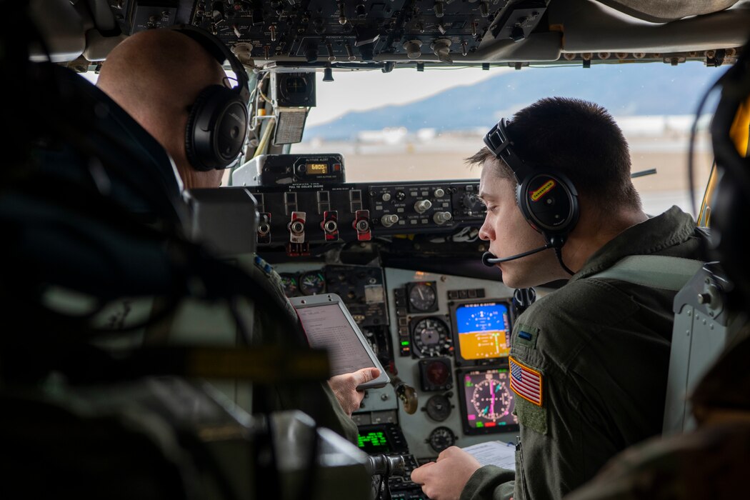 U.S. Air Force Reserve Capt. Jarred Logan, 465th Air Refueling Squadron KC-135 pilot, left, and First Lt. Kacey Christiansen, 465th Air Refueling Squadron KC-135 pilot, right, conduct preflight checks on a KC-135 Stratotanker during a total force training event