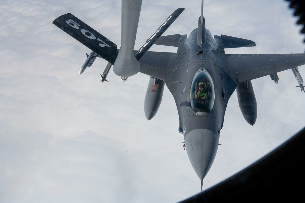 An F-16 Fighting Falcon pilot from the 555th Fighter Squadron conducts in-flight air refueling during a total force training event