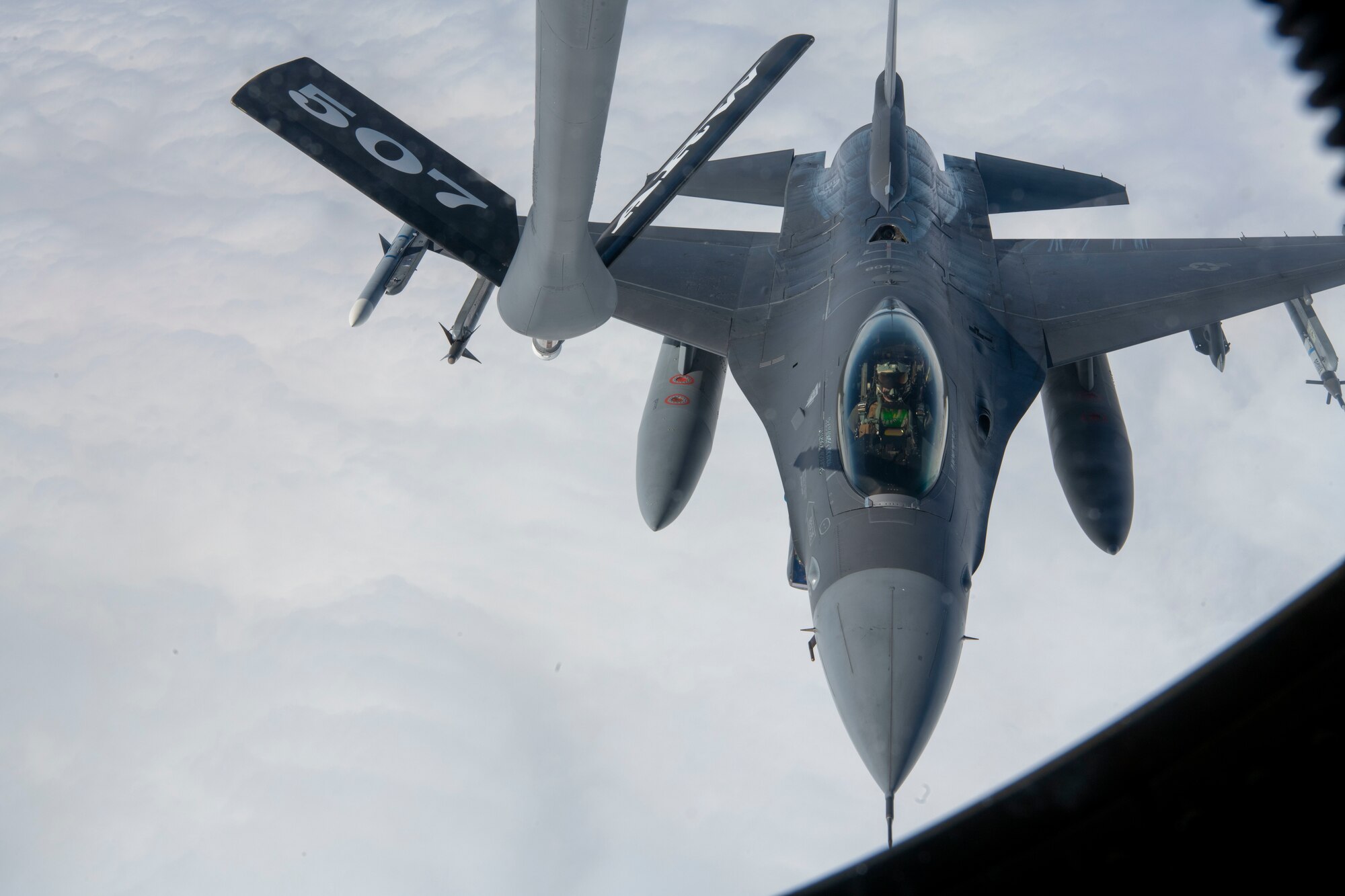 An F-16 Fighting Falcon pilot from the 555th Fighter Squadron conducts in-flight air refueling during a total force training event