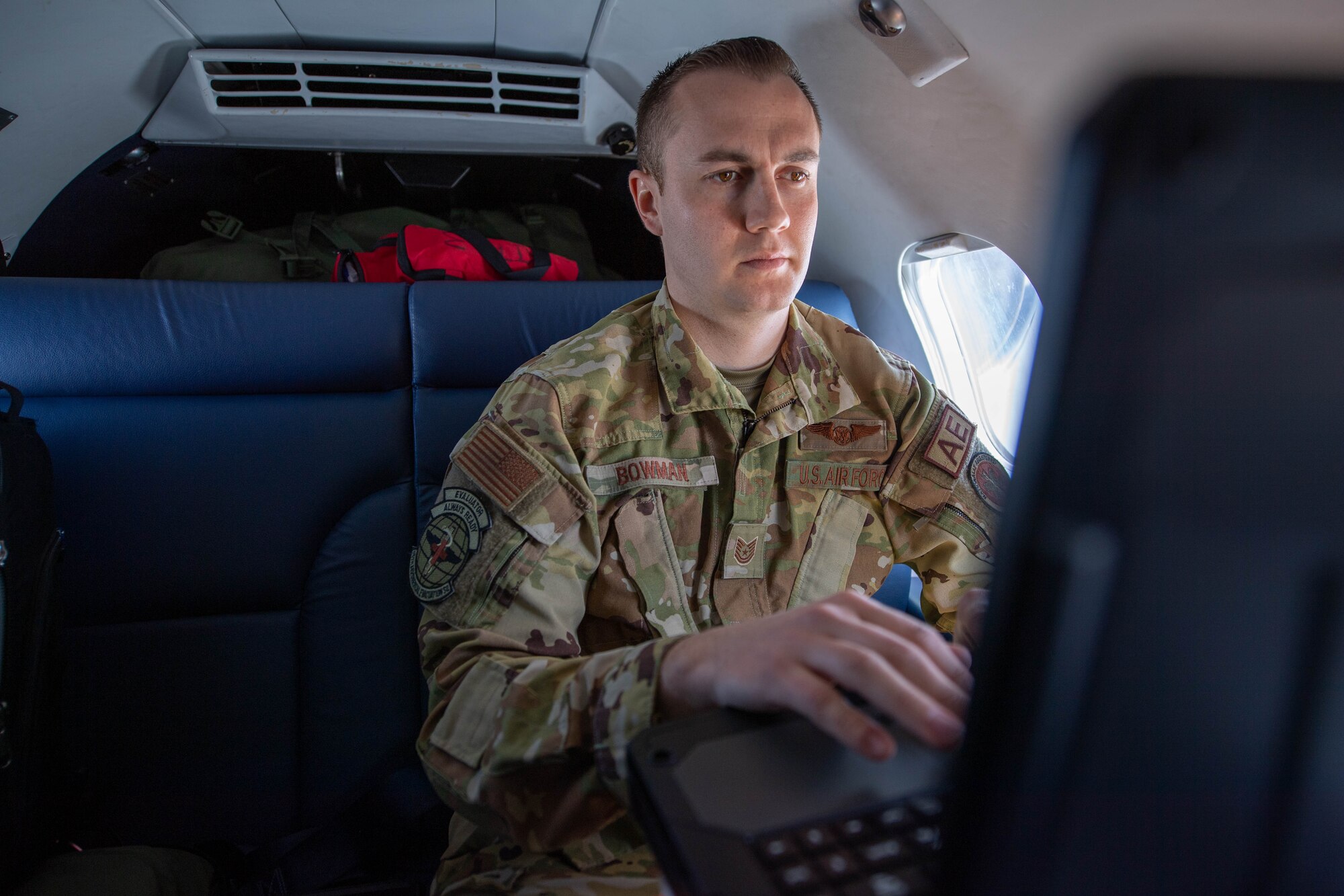 Tech. Sgt. Brendon Bowman, 86th Aeromedical Evacuation Squadron flight examiner and emergency medical paramedic, completes medical documents while transferring a patient from Vilnius International Airport, Lithuania, to Ramstein Air Base, Germany, April 6, 2023.
