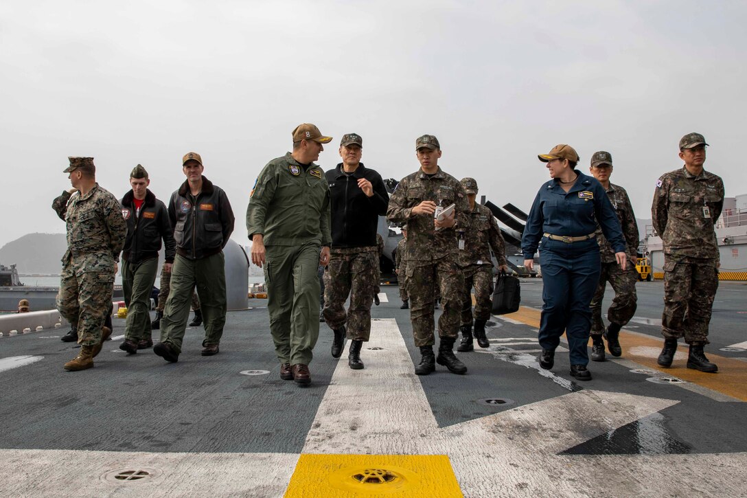 Capt. Tony Chavez, commanding officer of amphibious assault ship USS Makin Island (LHD 8), left center, and Capt. Andria Slough, executive officer of Makin Island, front right, give a tour of the flight deck for Vice Adm. Myung Soo Kim, commander, Republic of Korea (ROK) Fleet, center, during a key leader engagement aboard Makin Island for Operation Ssang Yong 2023, March 24 in South Korea. SY23 is a U.S./ROK joint landing drill to strengthen the alliance’s combat readiness, ensure tailored capabilities for defense, and improve interoperability to protect peace by strength. The Makin Island Amphibious Ready Group, comprised of Makin Island and amphibious transport docks USS Anchorage (LPD 23) and USS John P. Murtha (LPD 26), is operating in the U.S. 7th Fleet area of operations with the embarked 13th Marine Expeditionary Unit to enhance interoperability with Allies and partners and serve as a ready-response force to defend peace and maintain stability in the Indo-Pacific region.