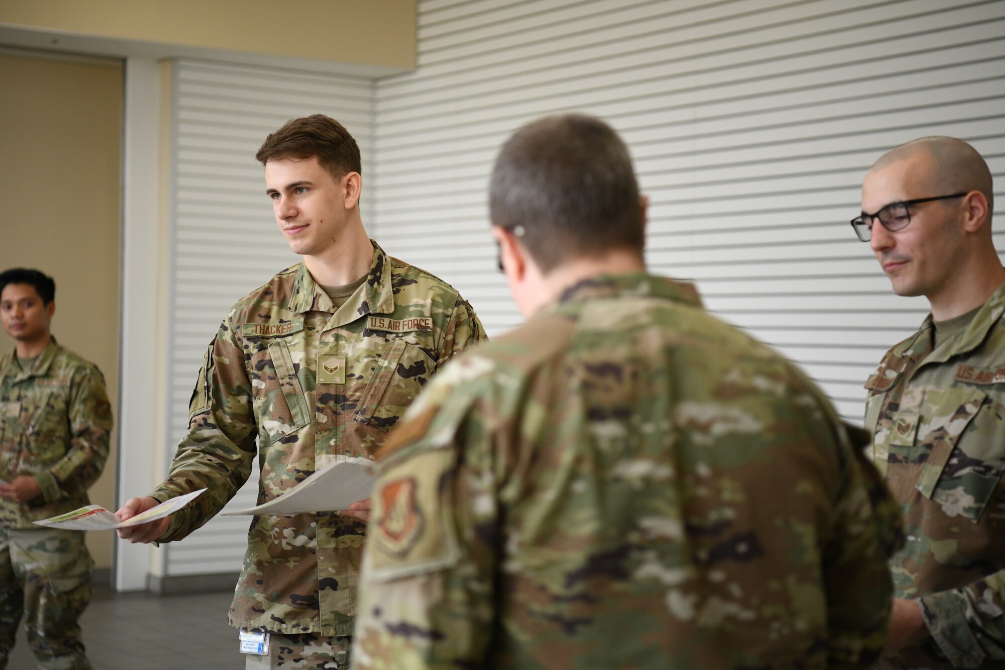 Airman 1st Class Nathan Thacker, 374th Operational Medical Readiness Squadron occupational health program manager, hands out helping agency flyers at Yokota Air Base, Japan, April 5, 2023. In recognition of National Public Health Week, Yokota’s Public Health clinic collaborated with mental health providers to spread awareness on domestic violence prevention and hosted classes about reproductive health. (U.S. Air Force photo by Staff Sgt. Spencer Tobler)