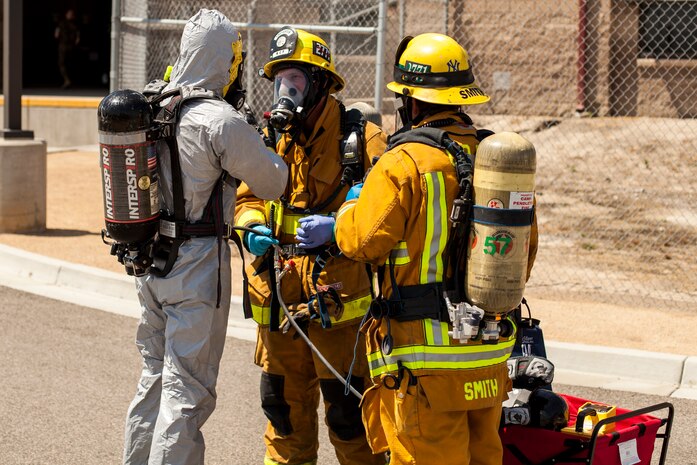 U.S. Marine Corps Explosive Ordnance Disposal Technician coordinates with Marine Corps Base Camp Pendleton Fire and Rescue during a bomb threat simulation at the Postal Operations Center, Marine Corps Installations West, Marine Corps Base Camp Pendleton, Calif., April 11, 2017. The regional command post exercise is comprised of a series of field training scenarios designed to improve regional command and control, enhance interagency coordination, and improve installation capabilities to respond to, and recover from, a crisis event and validate the installation mission assurance all-hazard plan.