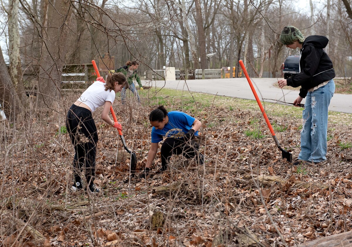 Students from the Fairborn High School Environmental Club help plant trees.