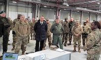 The commander of the 405th Army Field Support Brigade, Col. Crystal Hills, provides a group of distinguished visitors at the Long Term Equipment Storage and Maintenance Complex with a tour of the facility following the LTESM-C’s official opening ceremony in Powidz, Poland, April 5. The LTESM-C is comprised of 650,000 square feet of humidity-controlled warehouse space, a vehicle maintenance facility and supporting facilities, and a 58,000 square foot munitions storage area. (Photo by Lt. Col. Alan Manzo)