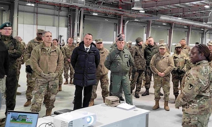 The commander of the 405th Army Field Support Brigade, Col. Crystal Hills, provides a group of distinguished visitors at the Long Term Equipment Storage and Maintenance Complex with a tour of the facility following the LTESM-C’s official opening ceremony in Powidz, Poland, April 5. The LTESM-C is comprised of 650,000 square feet of humidity-controlled warehouse space, a vehicle maintenance facility and supporting facilities, and a 58,000 square foot munitions storage area. (Photo by Lt. Col. Alan Manzo)