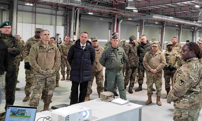 The commander of the 405th Army Field Support Brigade, Col. Crystal Hills, provides a group of distinguished visitors at the Long Term Equipment Storage and Maintenance Complex with a tour of the facility following the LTESM-C’s official opening ceremony in Powidz, Poland, April 5. The LTESM-C is comprised of 650,000 square feet of humidity-controlled warehouse space, a vehicle maintenance facility and supporting facilities, and a 58,000 square foot munitions storage area. (Photo by Lt. Col. Alan Manzo)