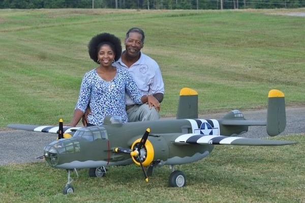 Man and Woman by model plane.