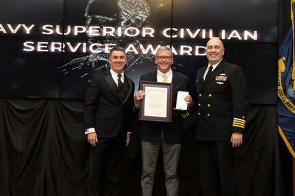 IMAGE: Naval Surface Warfare Center Dahlgren Division (NSWCDD) Technical Director Dale Sisson Jr., SES, and Commanding Officer Capt. Philip Mlynarski presented James Barnes with the Navy Meritorious Civilian Service Award during the NSWCDD Annual Honorary Awards ceremony at the Fredericksburg Expo & Conference Center March 10.