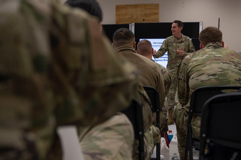 U.S. Air Force Chaplain (Capt.) Joshua Zarzana, a chaplain, speaks to service members during a Personnel Deployment Function on March 30, 2023, at Joint Base Anacostia-Bolling, Washington, D.C. PDFs allow service members to meet with unit representatives from around base to ask questions about family care, finances and other personnel-related matters prior to deployment. (U.S. Air Force photo by Jason Treffry)