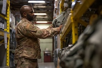 U.S. Air Force Staff Sgt. Bakari Robinson, 11th Wing Civil Engineer Squadron water fuel system maintenance specialist, selects chemical, biological, radiological and nuclear protective equipment during a Personnel Deployment Function on March 30, 2023, at Joint Base Andrews, Md. Service members are required to complete a PDF to ensure they are mentally and physically prepared for their upcoming deployment. (U.S. Air Force photo by Jason Treffry)