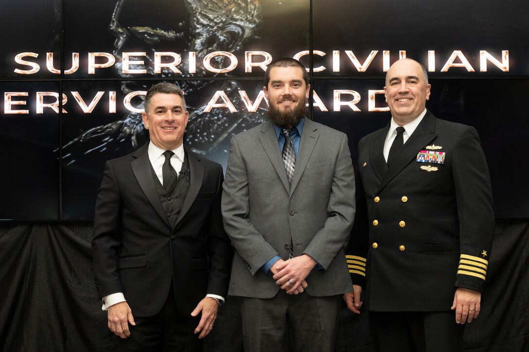 IMAGE: Naval Surface Warfare Center Dahlgren Division (NSWCDD) Technical Director Dale Sisson Jr., SES, and Commanding Officer Capt. Philip Mlynarski presented Daniel Belcher with the Navy Meritorious Civilian Service Award during the NSWCDD Annual Honorary Awards ceremony at the Fredericksburg Expo & Conference Center March 10.