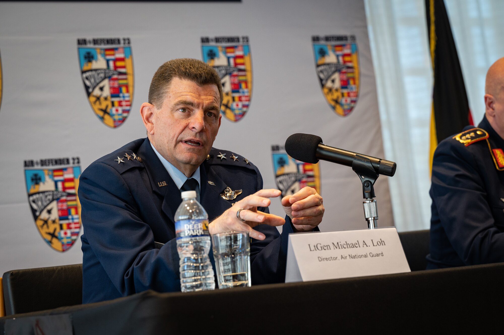 U.S. Air Force Lt. Gen. Michael A. Loh, left, director, Air National Guard, speaks at a press conference highlighting Air Defender 2023 at the German Embassy in Washington, D.C., April 4, 2023.