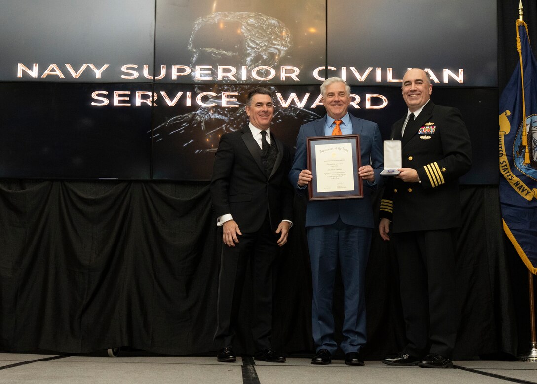IMAGE: Naval Surface Warfare Center Dahlgren Division (NSWCDD) Technical Director Dale Sisson Jr., SES, and Commanding Officer Capt. Philip Mlynarski presented Jonathan Dachos with the Navy Meritorious Civilian Service Award during the NSWCDD Annual Honorary Awards ceremony at the Fredericksburg Expo & Conference Center March 10.