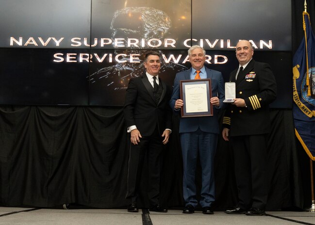 IMAGE: Naval Surface Warfare Center Dahlgren Division (NSWCDD) Technical Director Dale Sisson Jr., SES, and Commanding Officer Capt. Philip Mlynarski presented Jonathan Dachos with the Navy Meritorious Civilian Service Award during the NSWCDD Annual Honorary Awards ceremony at the Fredericksburg Expo & Conference Center March 10.
