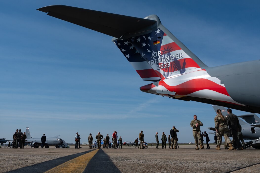 German and U.S. media and service members walk on the flight line during an Air Defender 2023 media event at Joint Base Andrews, Maryland, April 5, 2023.