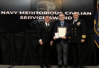 IMAGE: Naval Surface Warfare Center Dahlgren Division (NSWCDD) Technical Director Dale Sisson Jr., SES, and Commanding Officer Capt. Philip Mlynarski presented Thomas Moore with the Navy Meritorious Civilian Service Award during the NSWCDD Annual Honorary Awards ceremony at the Fredericksburg Expo & Conference Center March 10.