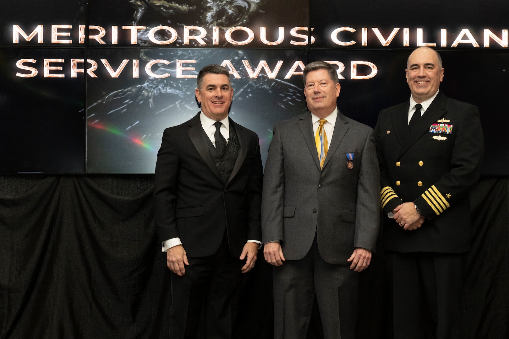 IMAGE: Naval Surface Warfare Center Dahlgren Division (NSWCDD) Technical Director Dale Sisson Jr., SES, and Commanding Officer Capt. Philip Mlynarski presented Matthew Zurasky with the Navy Meritorious Civilian Service Award during the NSWCDD Annual Honorary Awards ceremony at the Fredericksburg Expo & Conference Center March 10.