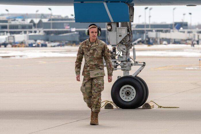 Airman 1st Class Jaxon Jeffries, 934th Aircraft Maintenance Squadron crew chief, walks away from Air Force One after positioing chalks at Minneapolis-St. Paul Air Reserve Station, April 3, 2023. (U.S. Air Force photo by Master Sgt. Trevor Saylor)