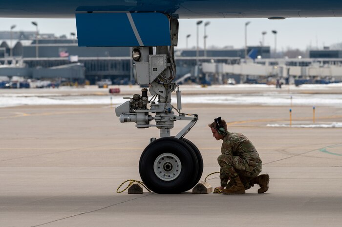 Airman 1st Class Jaxon Jeffries, 934th Aircraft Maintenance Squadron crew chief, positions chalks for Air Force One at Minneapolis-St. Paul Air Reserve Station, April 3, 2023. (U.S. Air Force photo by Master Sgt. Trevor Saylor)