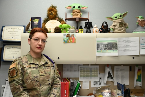 U.S. Air Force Staff Sgt. Seraiah Wolf, 17th Civil Engineer Squadron Airman dorm leader, poses with her Yoda collection at Goodfellow Air Force Base, Texas, April 6, 2023. Wolf has been enlisted since 2016. (U.S. Air Force photo by Airman 1st Class Madison Collier)