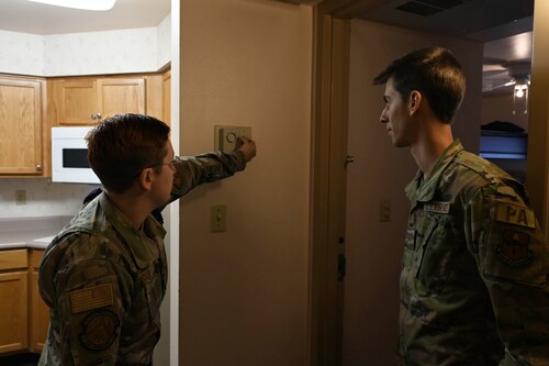 U.S. Air Force Staff Sgt. Seraiah Wolf, 17th Civil Engineer Squadron Airman dorm leader, gives Airman 1st Class Zachary Heimbuch, 17th Training Wing dorm resident, a tour at Goodfellow Air Force Base, Texas, April 6, 2023. Wolf spent her day answering questions and giving residents tours of their new building after a potential move was announced for permanent party residents. (U.S. Air Force photo by Airman 1st Class Madison Collier)