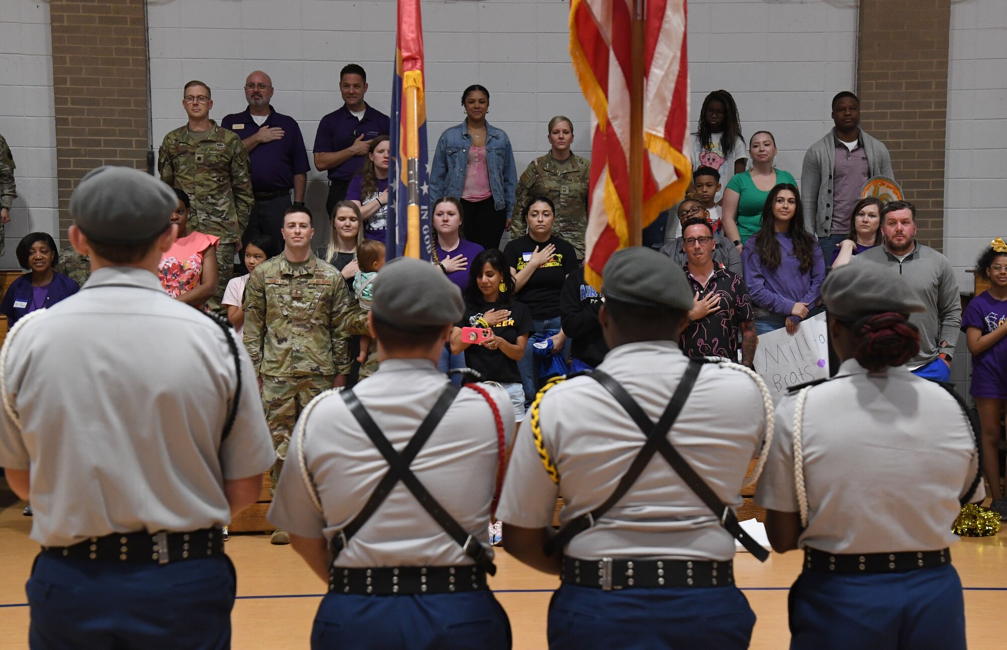 Keesler personnel stand for the presentation of colors by the Biloxi High School Jr. ROTC during a pep rally inside the Youth Center at Keesler Air Force Base, Mississippi, April 7, 2023.