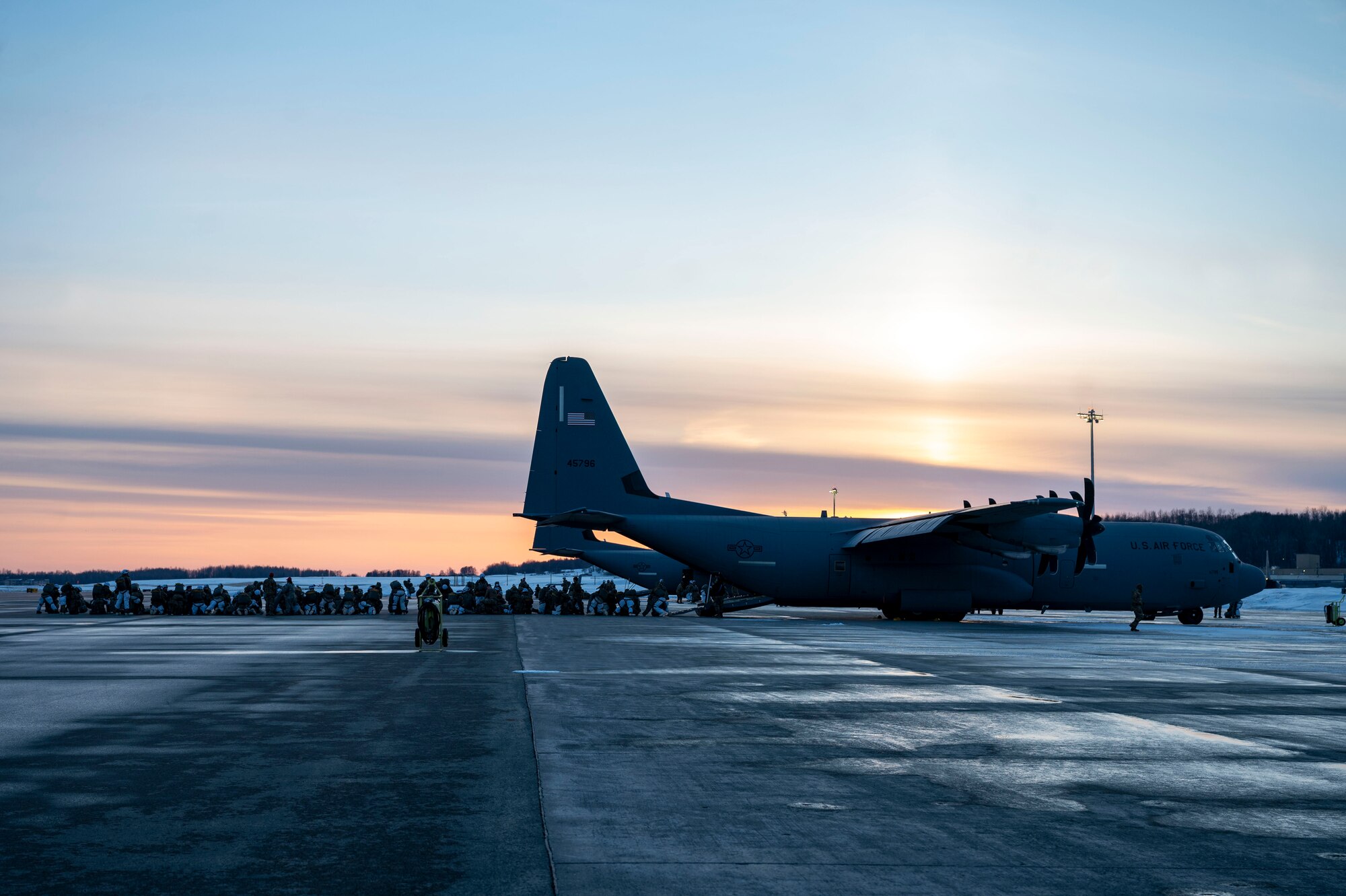U.S. Army personnel line up outside a C-130J Super Hercules