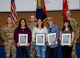 The Guyette family (LisaMarie, Joseph, Isabella, Angelina) receives the Volunteer of the Quarter Award from U.S. Army Maj. Gen. John V. Meyer III, the commanding general of the 1st Infantry Division and Fort Riley, and Command Sgt. Maj. Christopher L. Mullinax, the command sergeant major of the 1st Inf. Div. and Fort Riley, March 28, 2023, at Fort Riley, Kansas. The Guyette family received this reward for their involvement with the Junction City High School and 1st Heavy Attack Reconnaissance Squadron, 6th Cavalry Regiment, 1st Combat Aviation Brigade, 1st Inf. Div. Soldier and Family Readiness Group. (U.S. Army photo by Sgt. Alvin Conley)