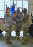 Col. Jeanne Bisesi, 433rd Mission Support Group commander, presents the 433rd Civil Engineer Squadron guidon to Maj. Bernard Wesley during an assumption of command ceremony at Joint Base San Antonio-Lackland, Texas, April 1, 2023.
